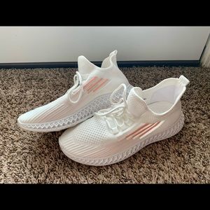 Women’s white and pink sneakers.